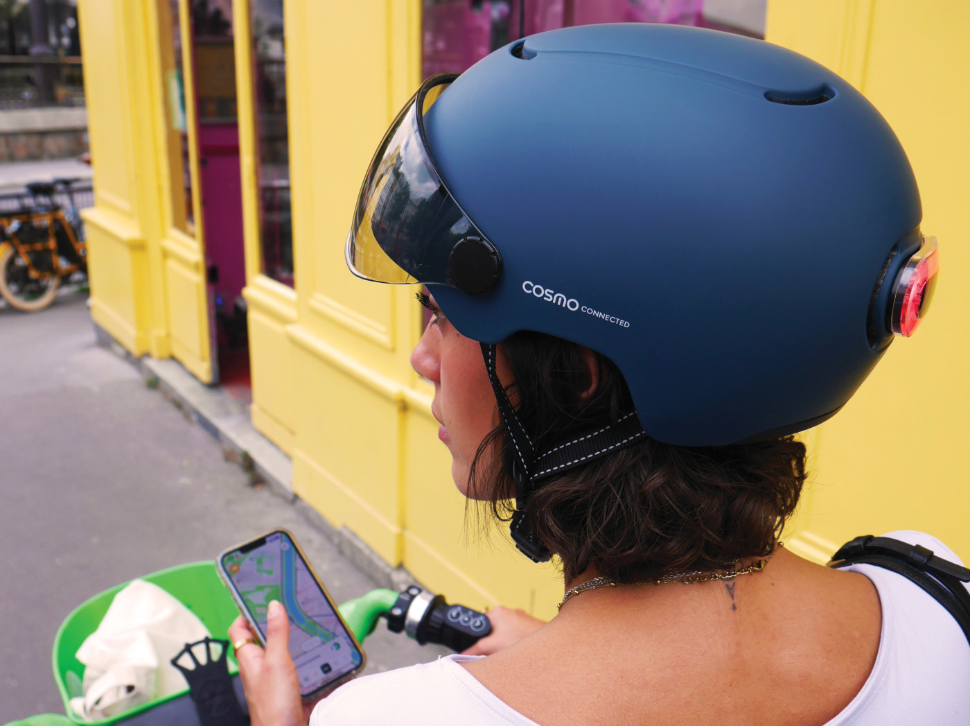 Cosmo Connected smart helmet with rear light near Eiffel Tower — showcasing innovative urban mobility gear enabled by GS1 GTINs and digital product data